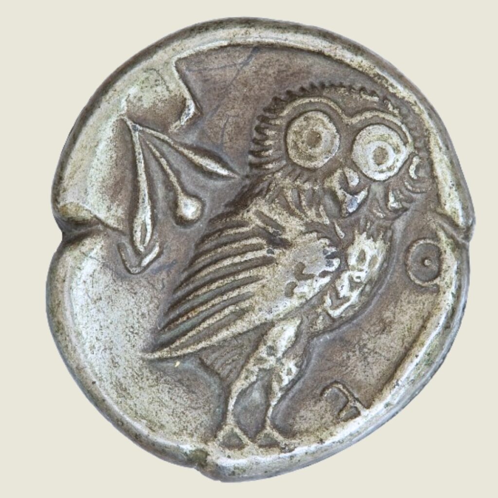 the-silver-coin-in-rusty-state-with-an-owl-on-it