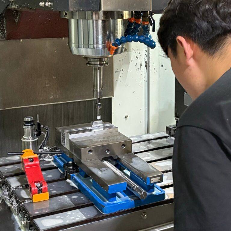 workers-are-performing-cnc-machining-and-observing-fixture-operation