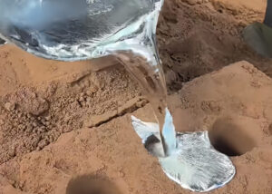 liquid-metal-pouring-in-brown-sand-sand-casting-scene-what-is-casting