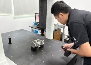 worker-measuring-aluminum-part