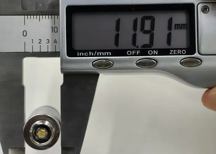 Digital caliper measuring a medical precision machined part to verify unilateral and bilateral tolerance requirements