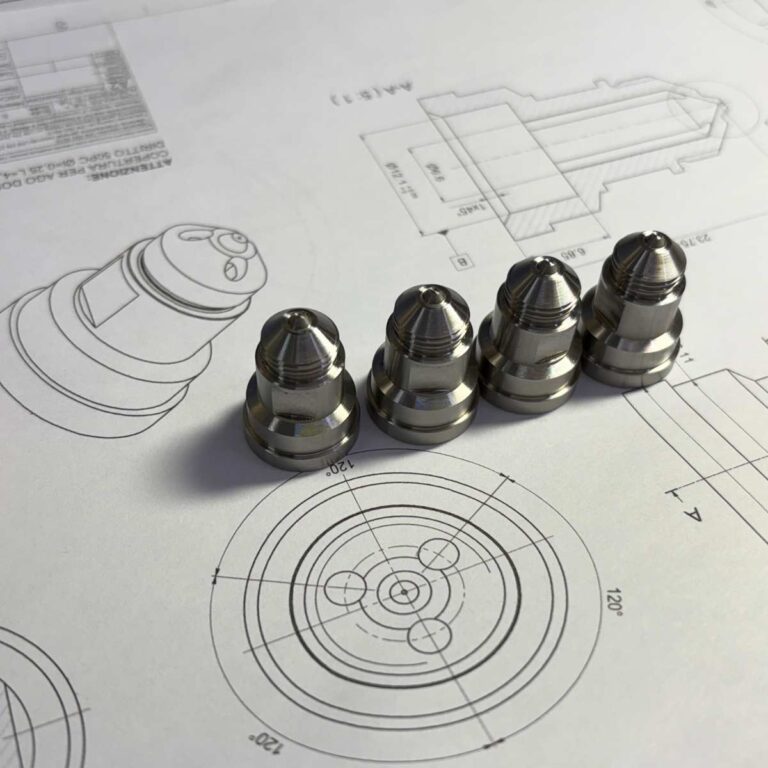 Aerospace CNC machined nozzles placed on engineering drawings for dimensional verification