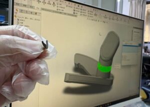 Engineer testing precision aerospace CNC machined prototype against 3D CAD model