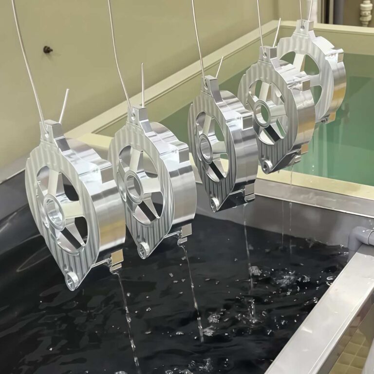 Aluminum parts racked and immersed in chromic acid anodizing electrolyte