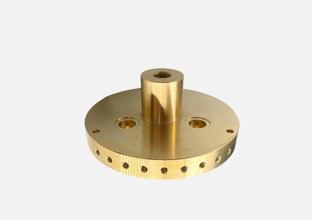 Precision CNC machined brass part with drilled holes and smooth surface finish