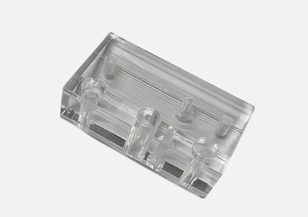 Transparent acrylic CNC machined block with multiple drilled channels
