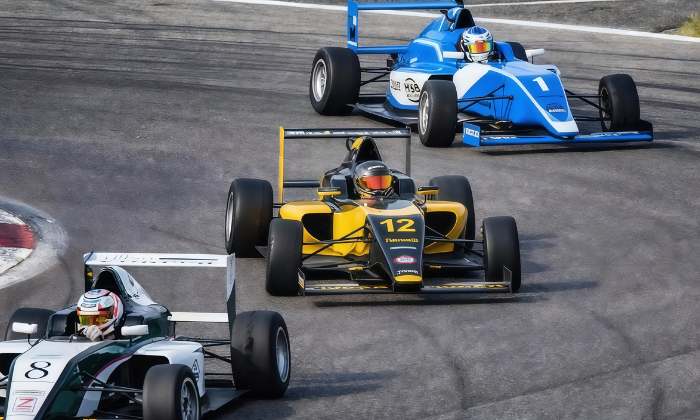 Formula race cars competing on a track