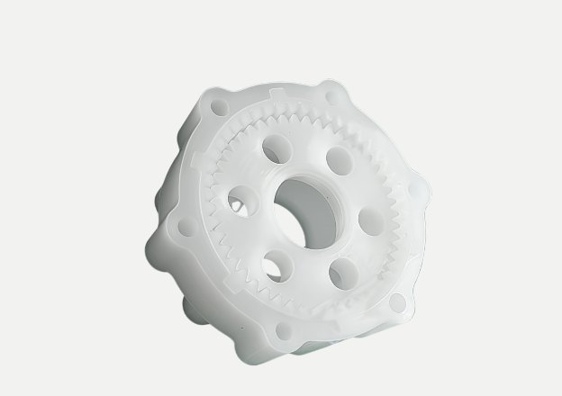 CNC machined white plastic gear component with multiple holes and teeth