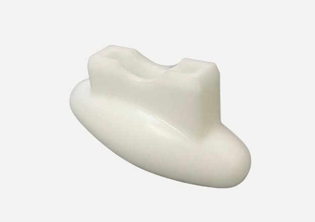 White plastic custom molded part with curved design and slot