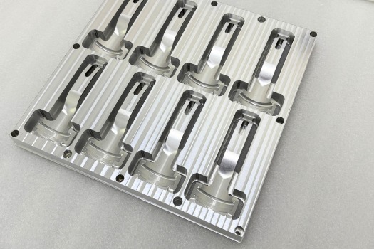 Aluminum rapid injection molding plate with multiple precision cavities machined for prototype mold testing and low-volume production.