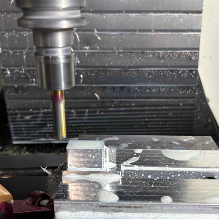 7075 aluminum undergoing high-precision CNC milling to produce a linkage component