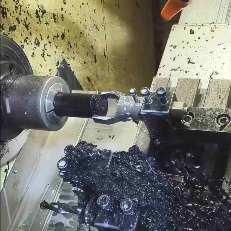 Acetal rod being turned on a CNC lathe, showing clean chip formation