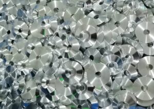 A batch of CNC-machined stainless steel washers with smooth, reflective surfaces