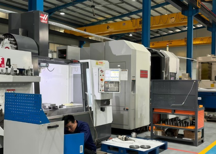Five-axis CNC milling machine displayed in a modern machining workshop