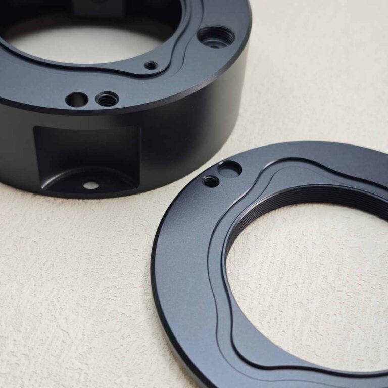 Black anodized aluminum part for automation equipment, showing high wear resistance and precision finish