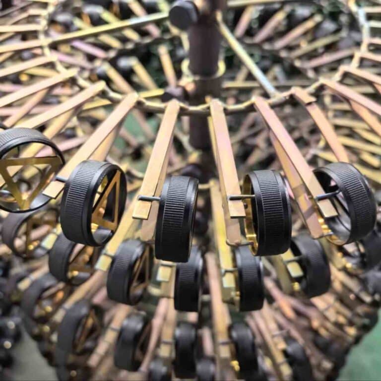 Black anodized 7075 aerospace aluminum parts neatly arranged on a shelf, used as a contrast to White Anodized Aluminum finishes