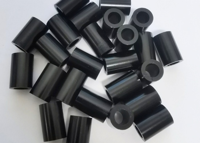 Black anodized aluminum tubes with smooth surface finish, showing uniform anodizing quality for industrial and precision applications.