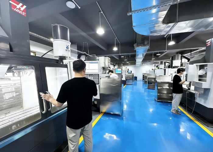 CNC machining workshop engineers communicating machining details on the shop floor