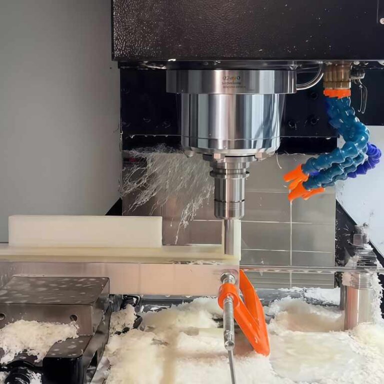 3 Axis CNC Machining of white POM plastic part during milling