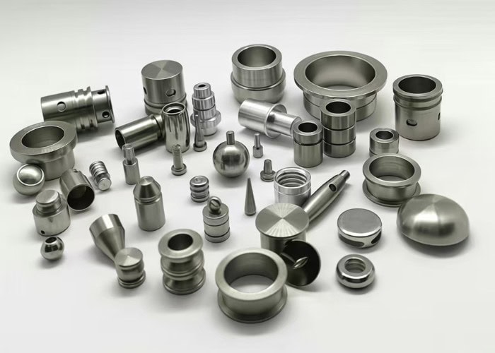 Various metal materials and precision parts suitable for CNC machining, including aluminum, stainless steel, and steel components