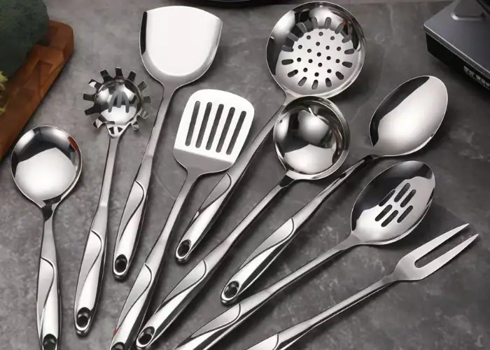 A set of 304 stainless steel kitchen utensils including ladles, slotted spoons, spatulas, and a serving fork