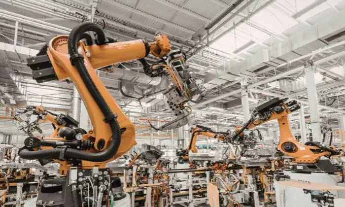 Modern factory scene with automated machinery processing industrial parts