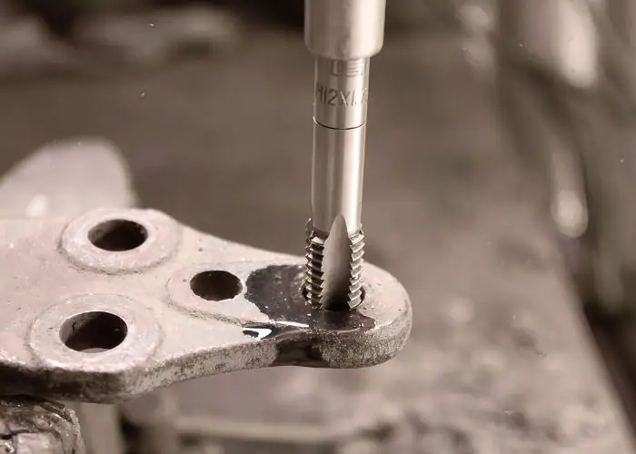 CNC drilling operation machining precision holes in metal part