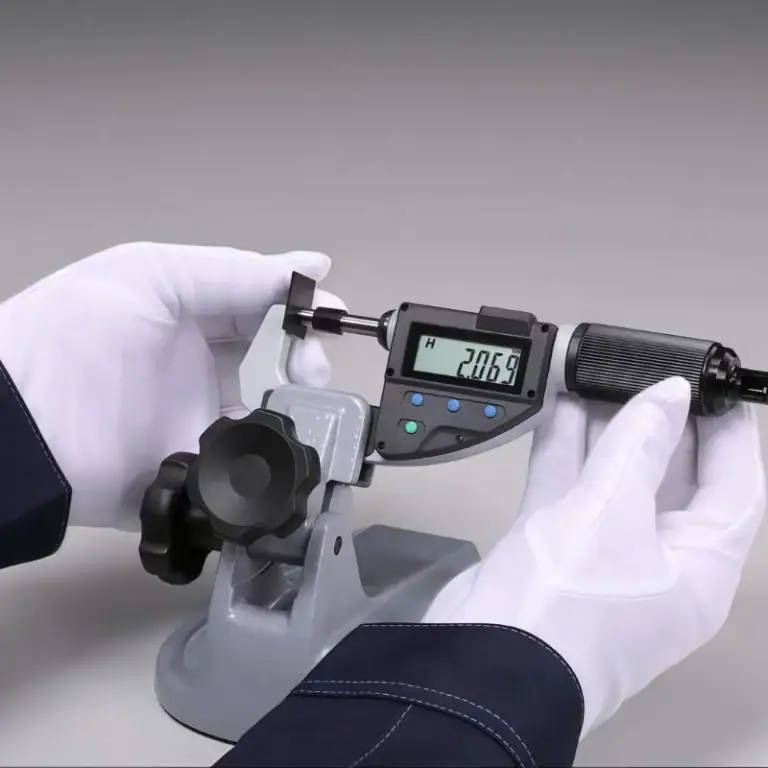 digital micrometer measuring thickness of a plastic part for precision inspection