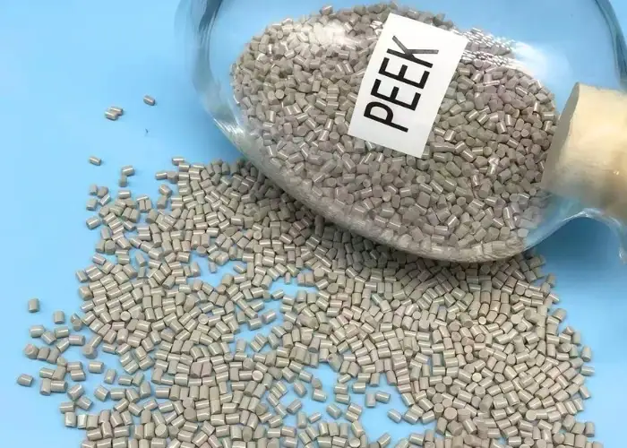 PEEK polymer pellets in gray, ideal for high-temperature and high-strength applications.