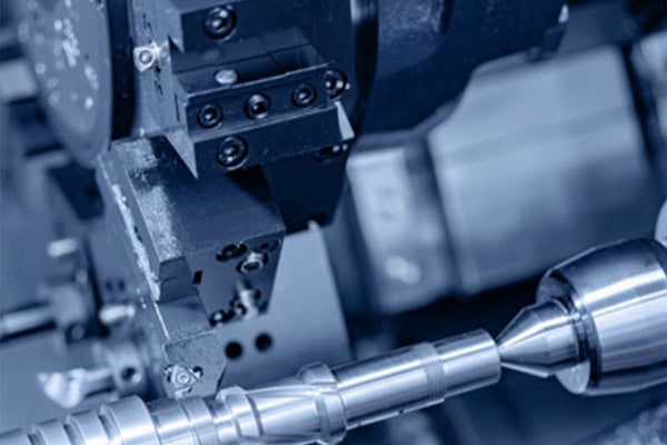 This is a picture of a CNC turret cutting a rotating workpiece.