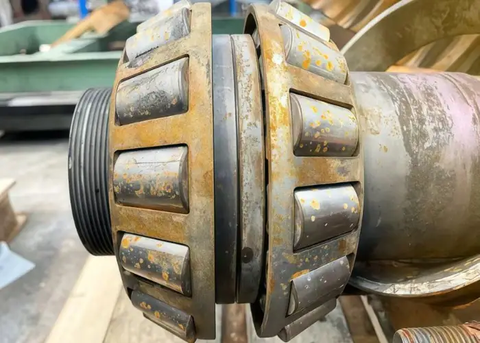 Close-up image of an industrial metal component showing visible corrosion damage