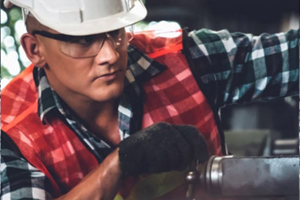This is a photo of factory workers operating industrial equipment.