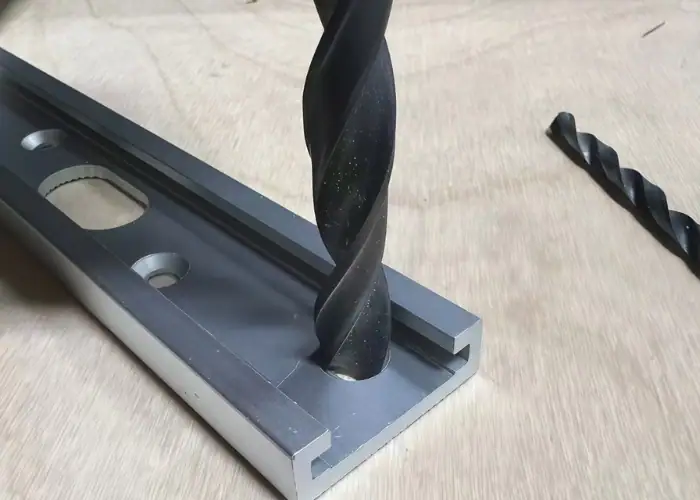 Drill bit machining countersink holes in a metal part