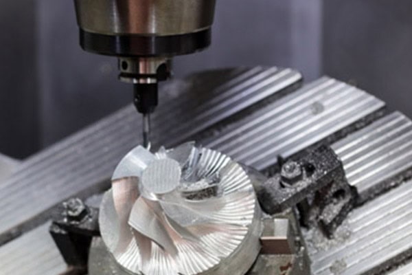 Images of precision milling operations performed by a CNC machining center.