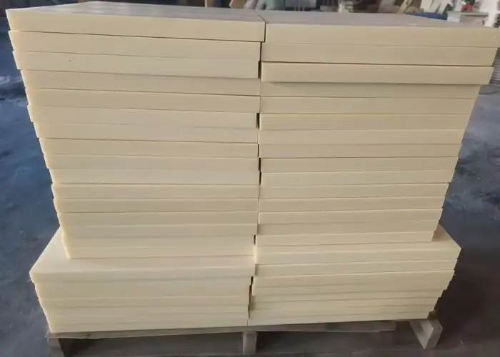 Cast MC Nylon sheet stock stacked on a pallet, prepared for CNC machining of wear-resistant industrial components