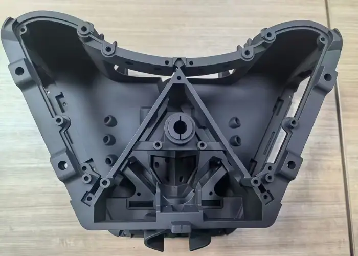 Insert molding automotive plastic housing with integrated ribs, bosses, and mounting features for vehicle parts