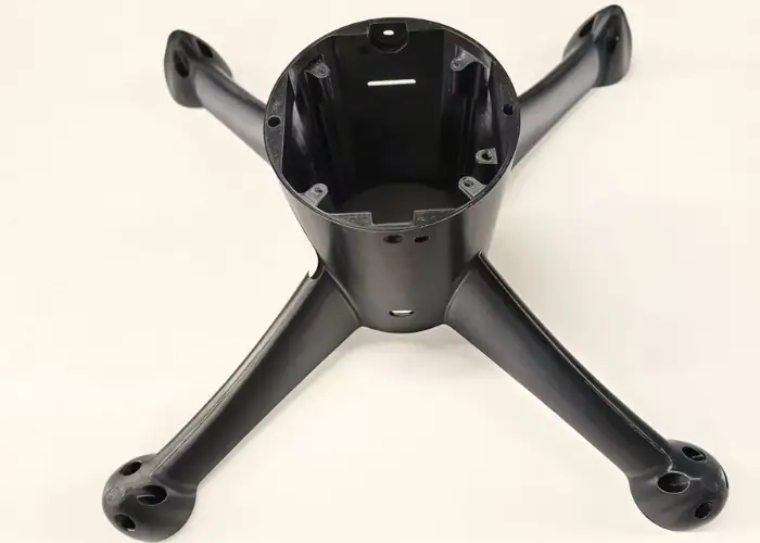 Machined MC Nylon drone frame structure with mounting holes and reinforced arms for lightweight industrial UAV components