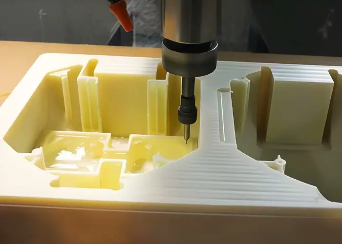 Small batch CNC machining of a plastic part, showing intricate details and precision milling