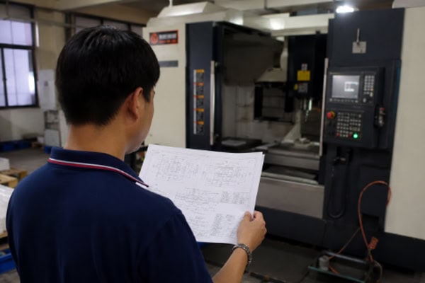 Engineers in the workshop inspect blueprints