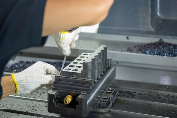 A CNC operator controls a CNC milling machine.
