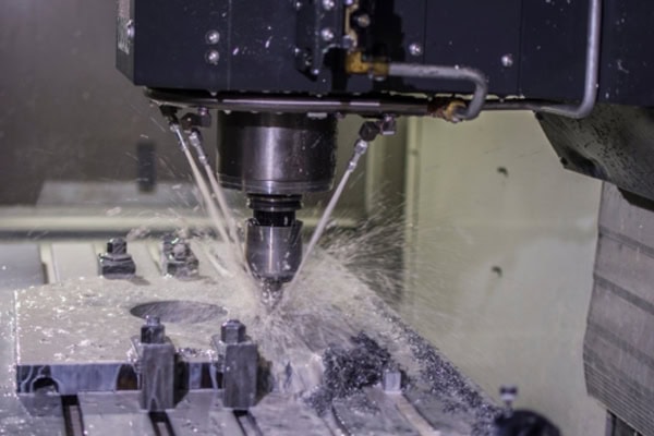 Machine tool spindle rotates at high speed to cut metal workpieces.