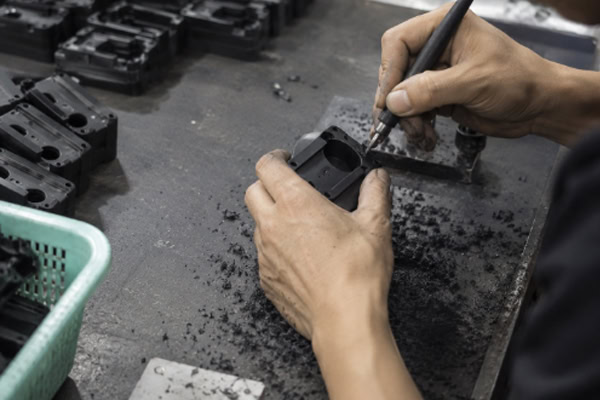 On-site deburring of CNC machined plastic parts using manual tools