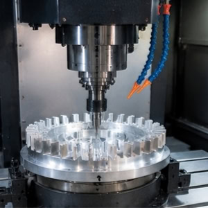 Precision machining with a fourth-axis CNC vertical machining center.