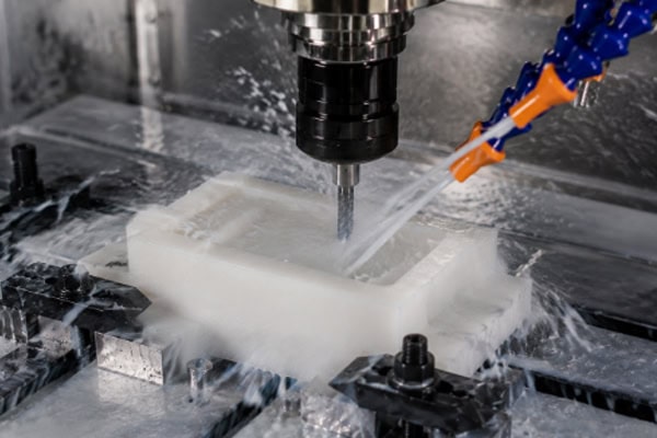 CNC machining in action with coolant
