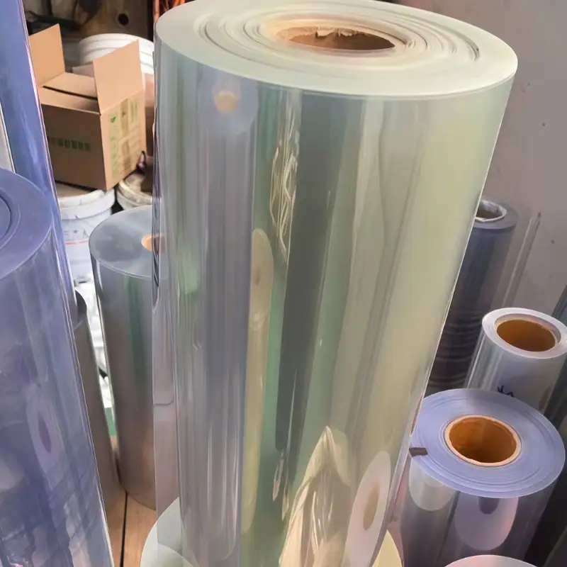 Transparent PET plastic film rolls stored as raw material for packaging, thermoforming, lamination, and industrial applications.