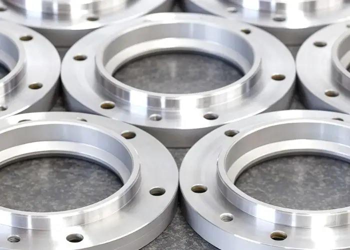 Aluminum flange electronic component with precision machined holes, threads, and mounting features