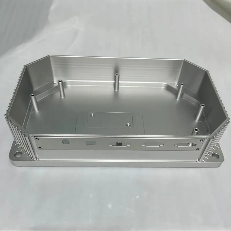 Bead-blasted aluminum electronic equipment housing with mounting bosses, connector interfaces, heat-sink fins, and internal cavities produced by precision CNC machining.