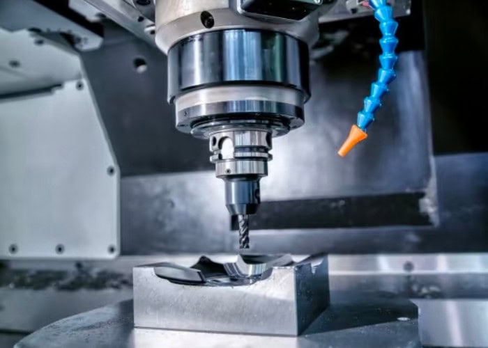 CNC milling machine cutting a metal workpiece with a rotating tool for precise machining