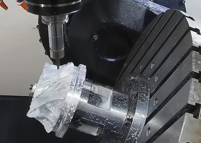 CNC cutter machining an impeller held on a rotary fixture