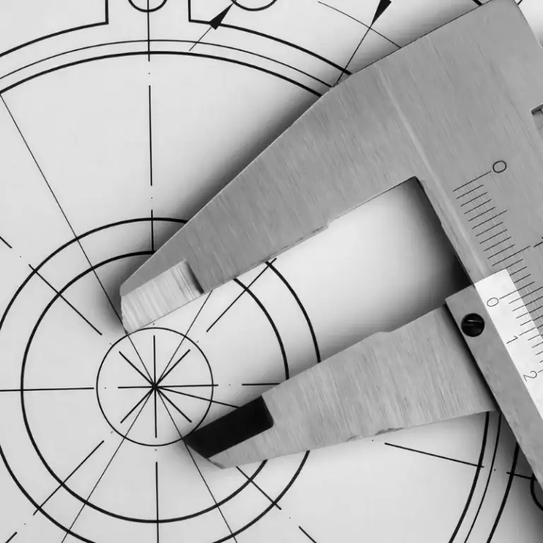 Scale ruler placed on engineering drawing to display and measure machining allowance dimension